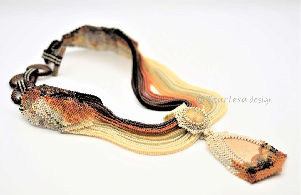 aries zodiac sign birthstones picture jasper crazy lace agate necklace. This necklace is created from tiny glass seed beads in colors of orange, yellow, cream, brown and black. Necklace pendant is made from Picture Jasper and Crazy Lace Agate stones.
